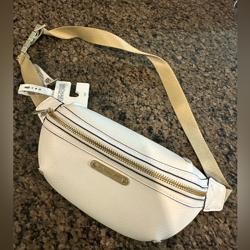 MICHAEL Michael Kors zipped belt bag in white leather with gold detail.